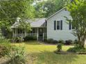 Charming single-Gathering home with covered porch and beautiful landscaped yard with lawn at 861 Creek Nw Trl, Kennesaw, GA 30144