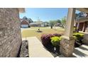 Inviting front porch view with well-maintained landscaping and neighborhood street at 8664 Spivey Village Trl, Jonesboro, GA 30236