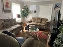 Cozy living room with hardwood floors, comfortable seating, and natural light at 1607 Hillview Ave, Jonesboro, GA 30236