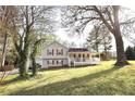 Charming home with a covered porch, red shutters, gray siding, and a detached two-car garage at 24 Lady Savannah Dr, Dallas, GA 30157