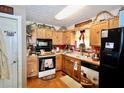 Quaint kitchen with wooden cabinets, black appliances, and charming country decor at 24 Lady Savannah Dr, Dallas, GA 30157