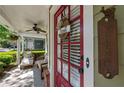 Charming front door with glass panels, welcome sign, and cozy seating on the inviting front porch at 4510 Flowering Br, Powder Springs, GA 30127