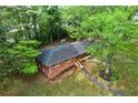 Aerial view of a charming brick home surrounded by lush greenery and mature trees at 800 Kiowa Ne Dr, Marietta, GA 30060