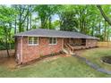 An eye-level exterior view showing the brick facade and tidy lawn of this inviting single story home at 800 Kiowa Ne Dr, Marietta, GA 30060