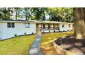 Beautiful white brick home with a cozy front porch and a stone walkway leading to the entrance at 800 Kiowa Ne Dr, Marietta, GA 30060