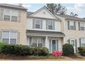 Inviting townhouse featuring a covered porch, blue shutters, and colorful landscaping at 10900 Wittenridge Dr # I4, Alpharetta, GA 30022