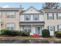 Lovely townhouse with blue shutters and blooming bushes enhancing its curb appeal at 10900 Wittenridge Dr # I4, Alpharetta, GA 30022