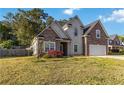 Beautiful two-story home with stone and siding details, an attached garage, and a vibrant front garden at 113 Highgrove Pl, Mcdonough, GA 30253