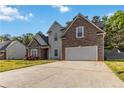 Appealing two-story home with stone accents, a two-car garage, and a large driveway at 113 Highgrove Pl, Mcdonough, GA 30253
