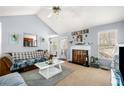 Inviting living room with vaulted ceiling, fireplace, and view of the kitchen at 33 Blue Springs Way, Dallas, GA 30157