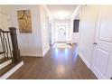 Bright and airy foyer with hardwood floors, a white front door, and neutral decor at 4881 Belle Estates Rd, Suwanee, GA 30024