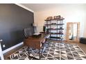 Well-lit office space featuring a stylish desk, modern shelving, and a patterned rug at 4881 Belle Estates Rd, Suwanee, GA 30024