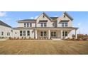 Beautiful two-story home with a brick facade, a covered porch, and a well-manicured lawn at 5130 Travers Ln, Cumming, GA 30040
