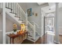 Bright foyer with hardwood floors, staircase, and elegant lighting fixtures at 957 Piedmont Ne Ave # A, Atlanta, GA 30309