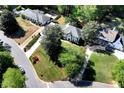 Beautiful aerial view of neighborhood homes with mature trees and green lawns on a sunny day at 2648 Kenwood Dr, Duluth, GA 30096