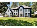 Charming two-story home featuring a manicured lawn and striking black and white accents at 2648 Kenwood Dr, Duluth, GA 30096