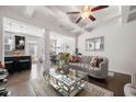 Open-concept living room featuring coffered ceilings, hardwood floors, and elegant furnishings at 2709 Kemp Court, Conyers, GA 30094