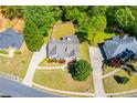 An aerial shot captures the house, showcasing its surrounding lawn, driveway, and neighborhood at 4066 Harvest Ridge Dr, Douglasville, GA 30135