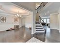 Grand foyer with hardwood floors, staircase, and chandelier at 5525 Nesmith Ct, Cumming, GA 30040
