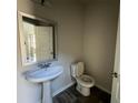 Half-bathroom with pedestal sink and dark wood floors at 231 Creek View Pl, Canton, GA 30114
