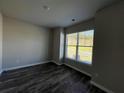 Bright bedroom with hardwood floors and a large window providing ample natural light at 231 Creek View Pl, Canton, GA 30114