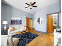 Living room with hardwood floors, ceiling fan, sofa, and access to the Primary bathroom at 2630 Talley St # 319, Decatur, GA 30030