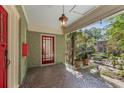 Inviting front porch with stone flooring, pendant light, and views of the surrounding garden at 374 8Th Ne St, Atlanta, GA 30309