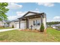 Single-story home with well-manicured lawn and landscaping, including a view of the house number at 7757 Sheffield Ter, Fairburn, GA 30213
