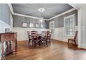 Elegant dining room with hardwood floors, wainscoting, and a stylish chandelier at 3318 Monceau Way, Roswell, GA 30075