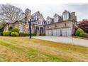 Charming two-story home with a three-car garage, basketball hoop, and lush green lawn at 3318 Monceau Way, Roswell, GA 30075