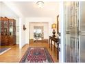 Elegant foyer with hardwood floors, decorative rug, and bright lighting fixture at 4579 Blakedale Ne Cir, Roswell, GA 30075