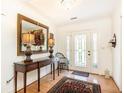 Inviting foyer with white trim, hardwood floors, and glass-paneled front door at 4579 Blakedale Ne Cir, Roswell, GA 30075