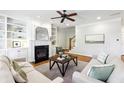 Bright living room features built-in shelving, fireplace, and hardwood floors at 1605 Gilstrap Nw Ln, Atlanta, GA 30318