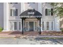 Inviting building entrance featuring a striped awning and classic architectural details at 3648 Peachtree Ne Rd # 2Q, Atlanta, GA 30319