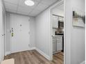 Clean hallway leading to a kitchen area, showcasing modern fixtures and finishes at 3648 Peachtree Ne Rd # 2Q, Atlanta, GA 30319