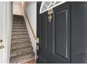 Townhome entrance showcasing a staircase with carpeted steps and a classic front door with a knocker at 375 Highland Ne Ave # 1011, Atlanta, GA 30312
