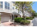 Inviting townhome exteriors with well-maintained landscaping and attached garages on a sunny day at 375 Highland Ne Ave # 1011, Atlanta, GA 30312