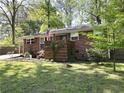 Quaint brick home with an American flag and updated wood railing at 4257 Webb Rd, Tucker, GA 30084