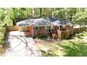 Aerial view of brick home with lush green lawn, mature trees, and a long driveway at 4257 Webb Rd, Tucker, GA 30084