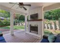 Spacious backyard with a covered patio featuring a brick fireplace and overlooking a well-manicured yard at 1282 Fairhill Ne Ln, Atlanta, GA 30319