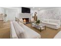 Spacious living room with a fireplace and elegant white sofas at 1305 Old Woodbine Rd, Atlanta, GA 30319