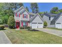 Charming two-story home featuring red shutters and a two-car garage at 2477 Lakebrooke Dr, Marietta, GA 30066