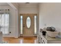 Inviting foyer with decorative door, hardwood floors and modern console table at 2477 Lakebrooke Dr, Marietta, GA 30066