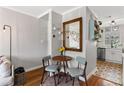 Bright dining area with wood floors, a round table with chairs, and an adjacent kitchen enhancing the living space at 542 Goldsboro Ne Rd # C, Atlanta, GA 30307