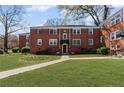 Charming brick apartment building with manicured lawn and sidewalk leading to the main entrance at 542 Goldsboro Ne Rd # C, Atlanta, GA 30307