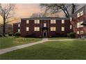 Charming red brick building with well-manicured lawn and vibrant azalea bushes at dusk at 542 Goldsboro Ne Rd # C, Atlanta, GA 30307