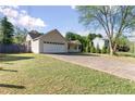 Inviting ranch home with a large driveway and a two-car garage, all set on a well-maintained lawn at 1222 W Wylie Bridge Rd, Woodstock, GA 30188