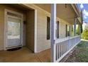 This lovely home features a cozy front porch, wood-like vinyl siding, and decorative dark shutters at 1222 W Wylie Bridge Rd, Woodstock, GA 30188