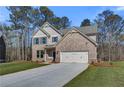 Charming two-story brick home with a well-manicured lawn and attached two-car garage at 128 Felicity Pike, Locust Grove, GA 30248