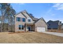 Charming two-story brick home with a well-manicured lawn and attached two-car garage at 128 Felicity Pike, Locust Grove, GA 30248